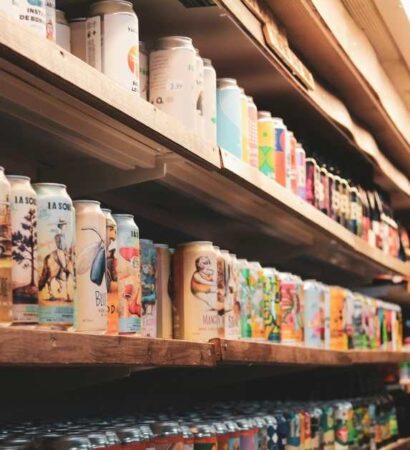 Ola Mate Featured Image Shelves stocked with a variety of packaged beverages in a retail store.