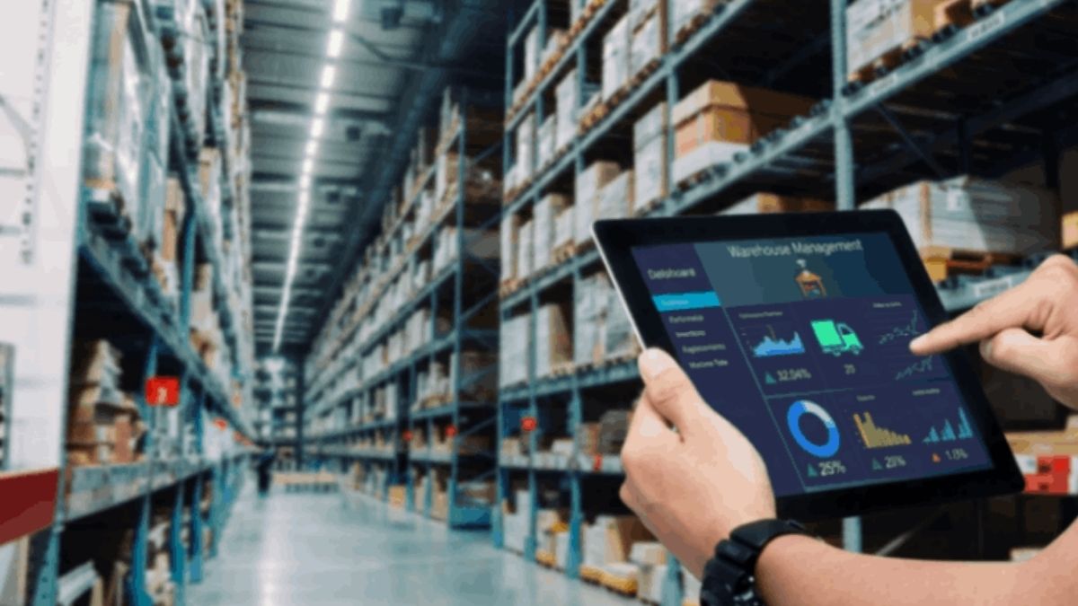 Warehouse employee reviewing inventory data on a tablet for a business evaluating bookkeeping services near me.