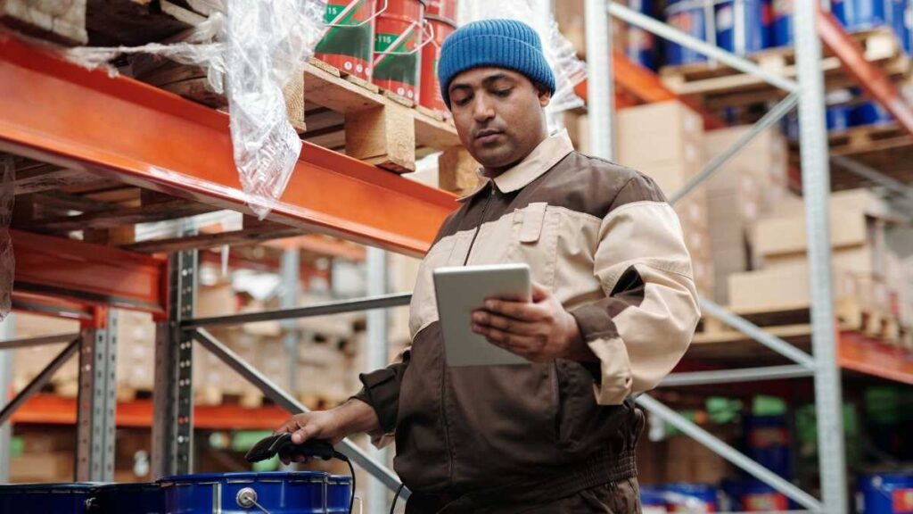 Warehouse worker using tablet for inventory checks