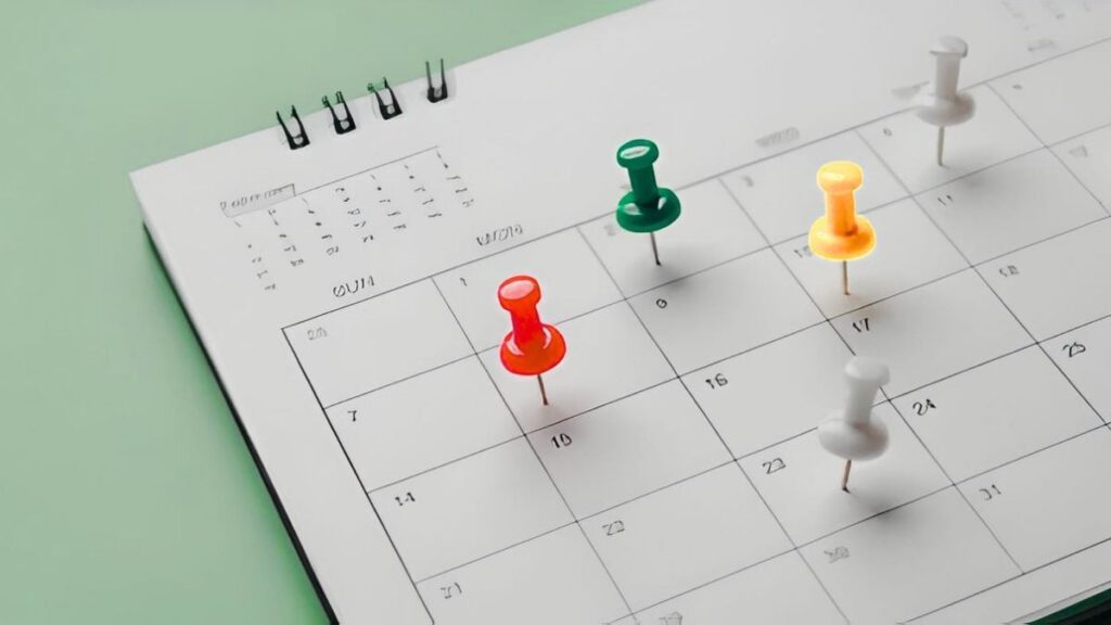 Calendar with colored pins marking key review dates.