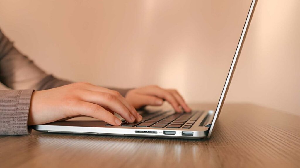 Bookkeeper managing inventory records on a laptop