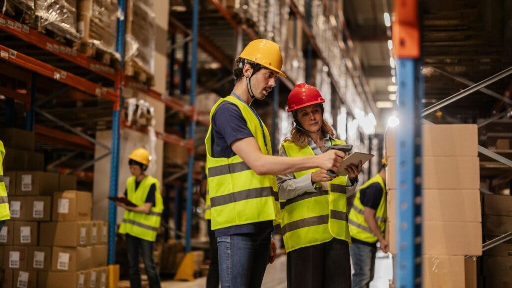 Warehouse workers checking stock using inventory management tips